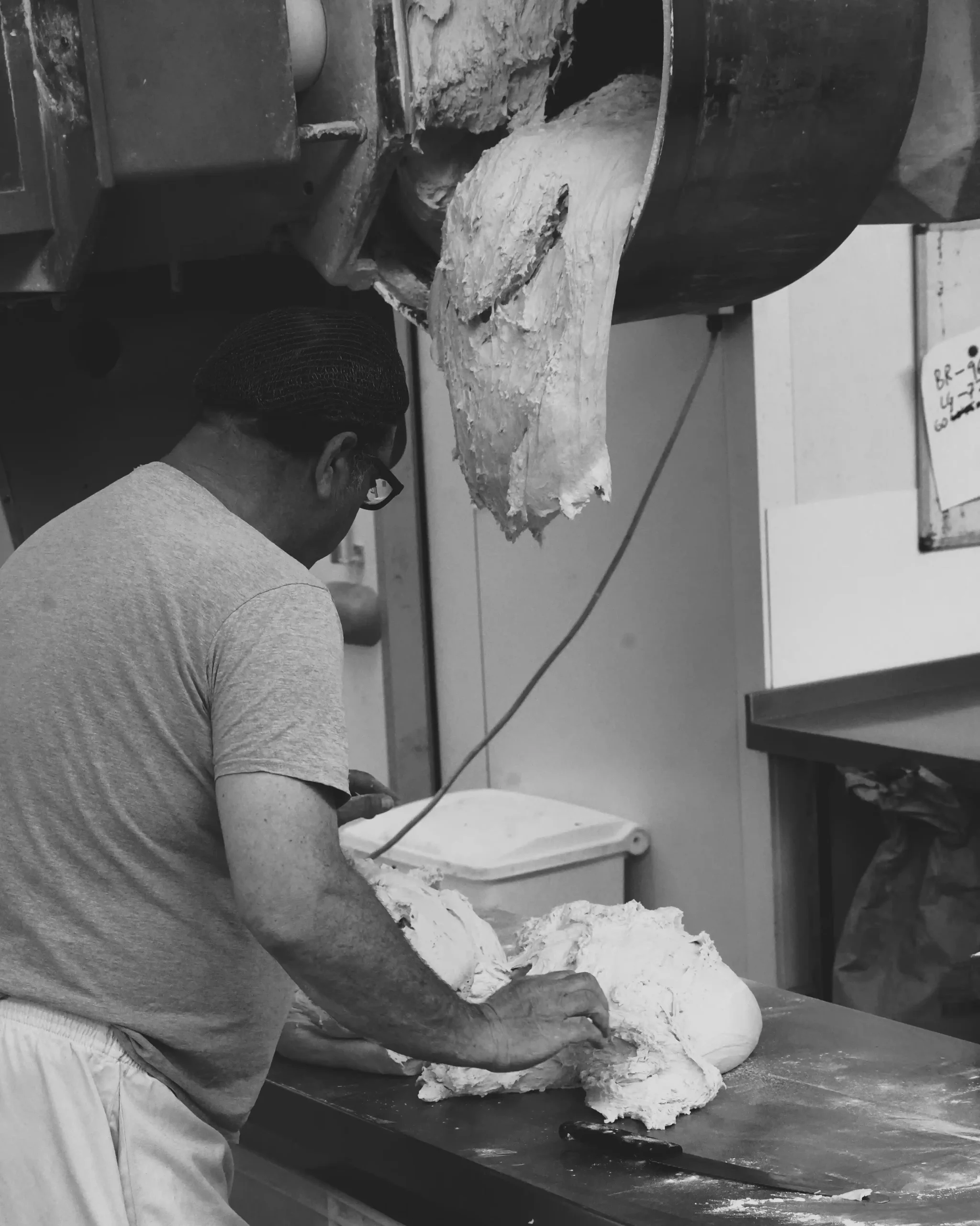 One of our bakers prepping dough, cutting it into smaller pieces for the proofing boxes.
